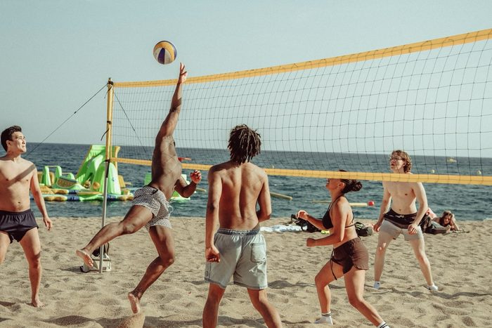 A game of beach volleyball on the sand by the sea