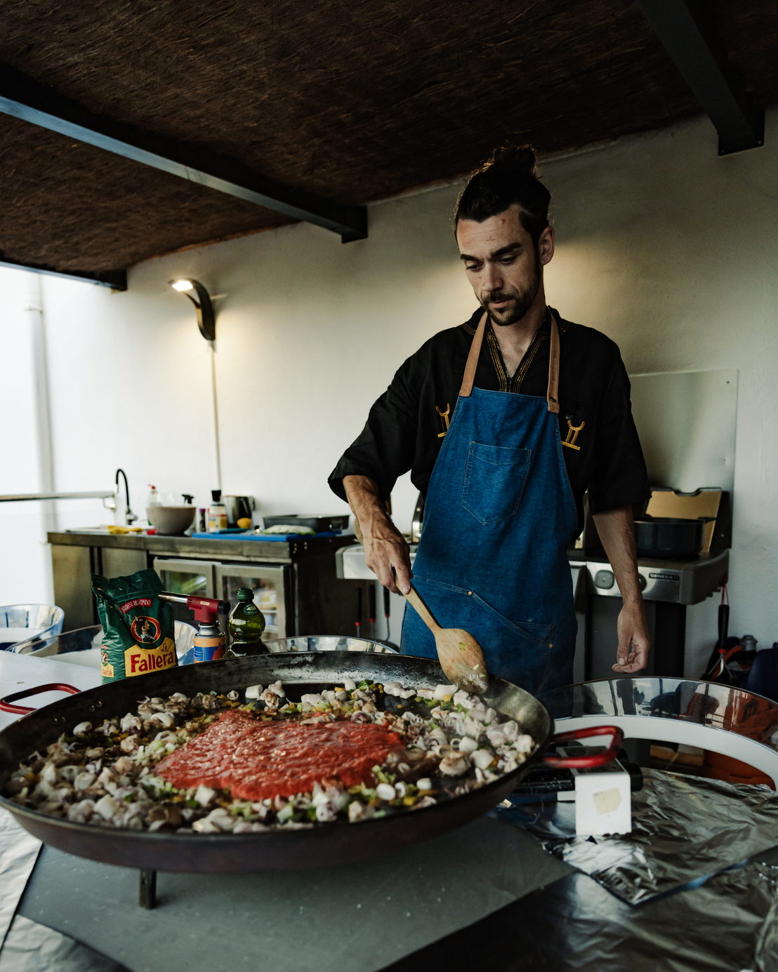 Private chef cooking a large paella at the villa