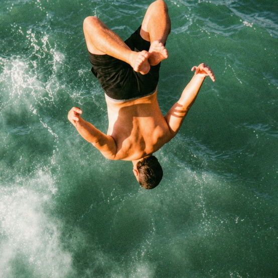 Backflip into a rolling green sea